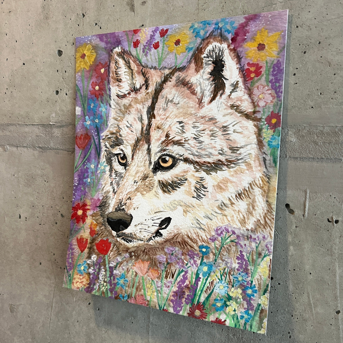 painting of a wolf surrounded by wildflowers