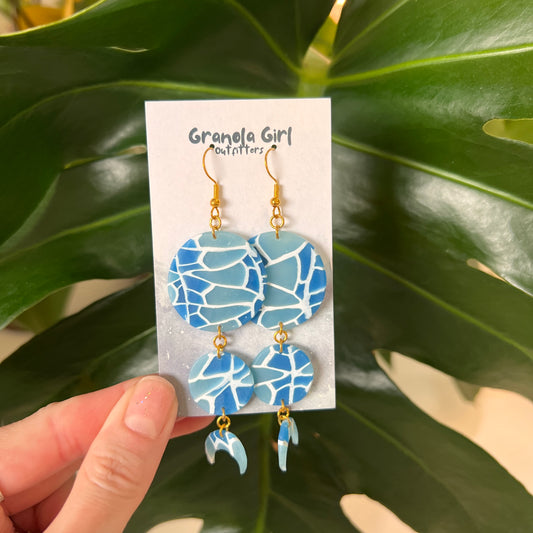 Blue mosaic earrings on a 'Granola Girl Outfitters' card with green leaves in the background