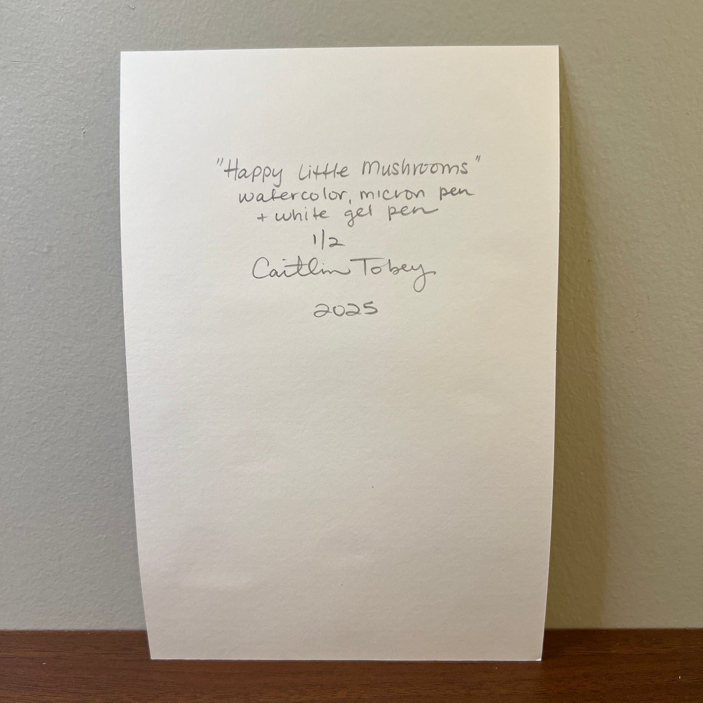 back of watercolor paper with handwritten artist signature and painting info