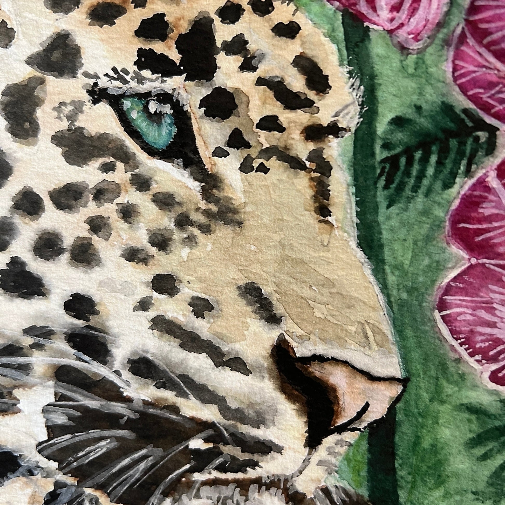 Close-up of a leopard's face with floral background
