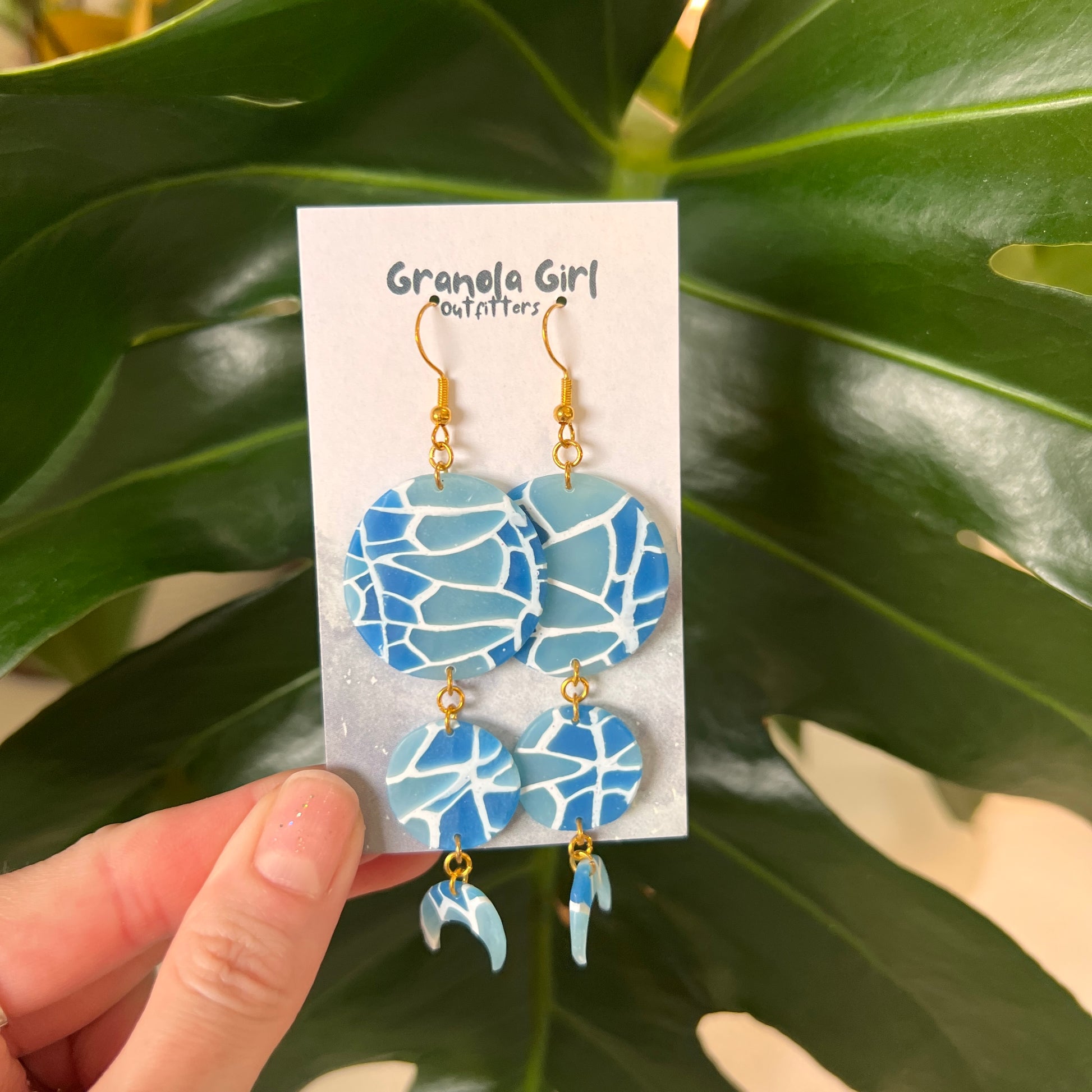 Blue mosaic earrings on a 'Granola Girl Outfitters' card with green leaves in the background