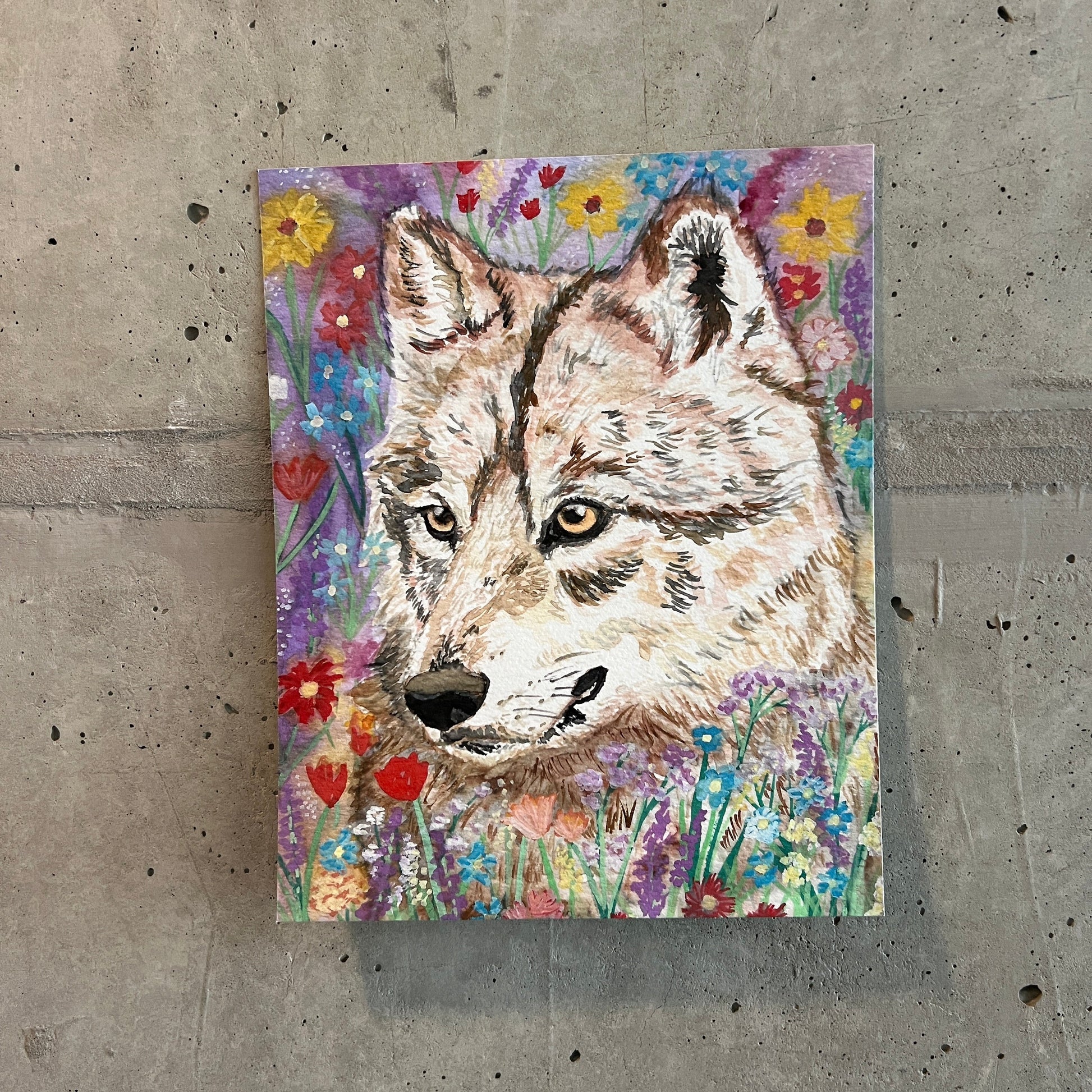 painting of a wolf surrounded by wildflowers