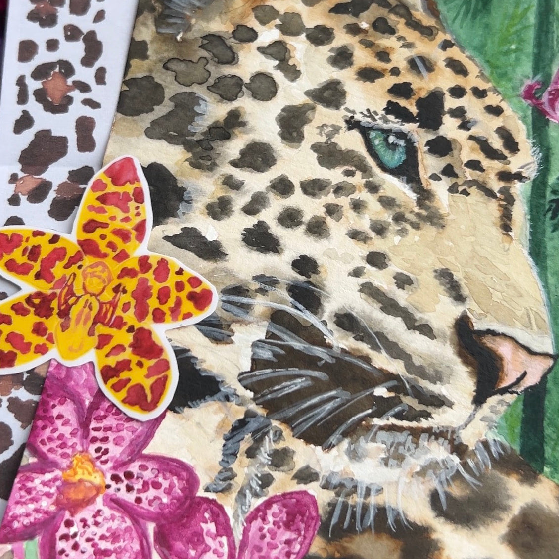 Image closeup of a leopard Art print and orchid sticker 