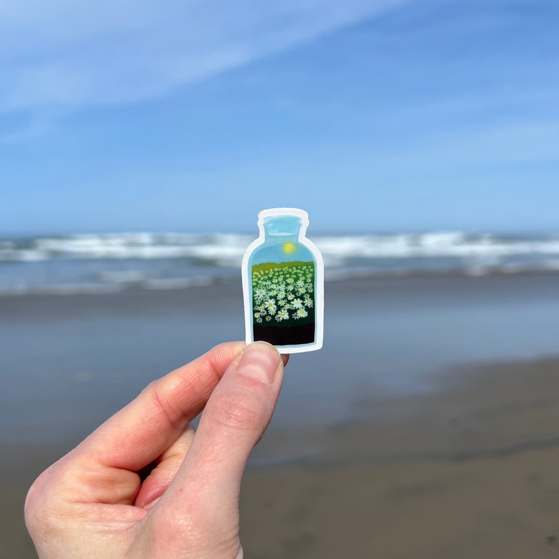 Hand holding a daisy terrarium sticker