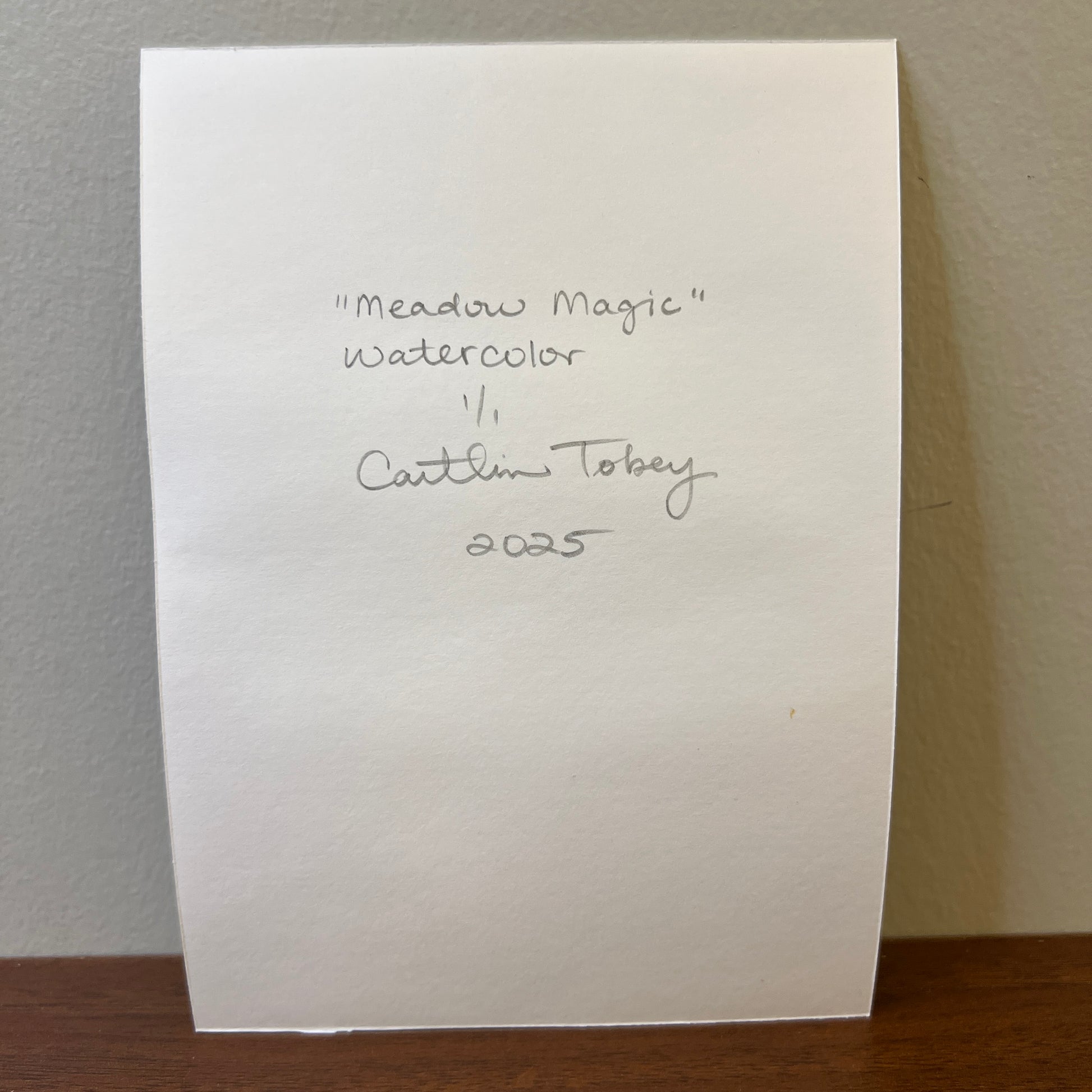 back of watercolor paper with handwritten artist signature and painting info
