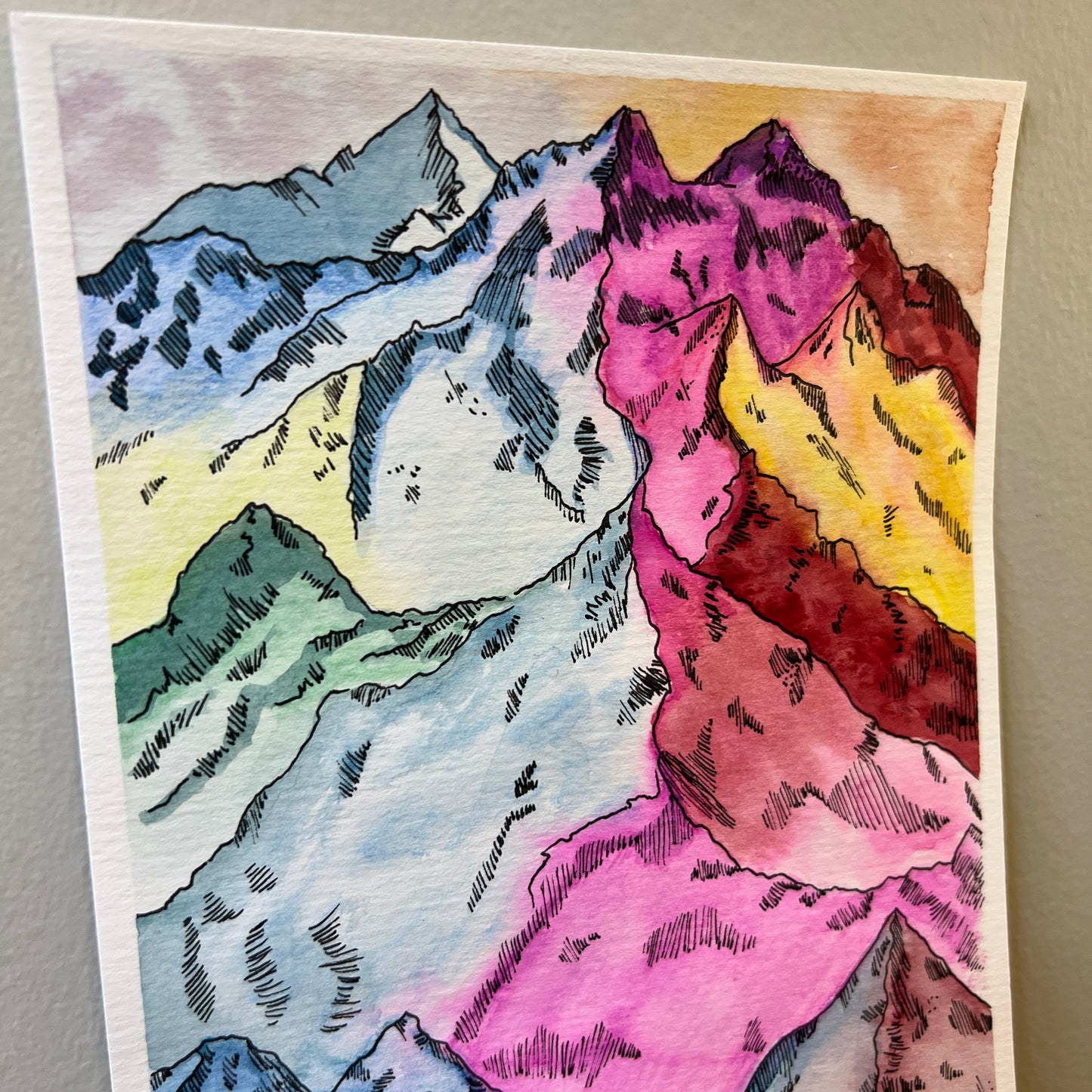 Colorful mountain illustration on a textured watercolor paper