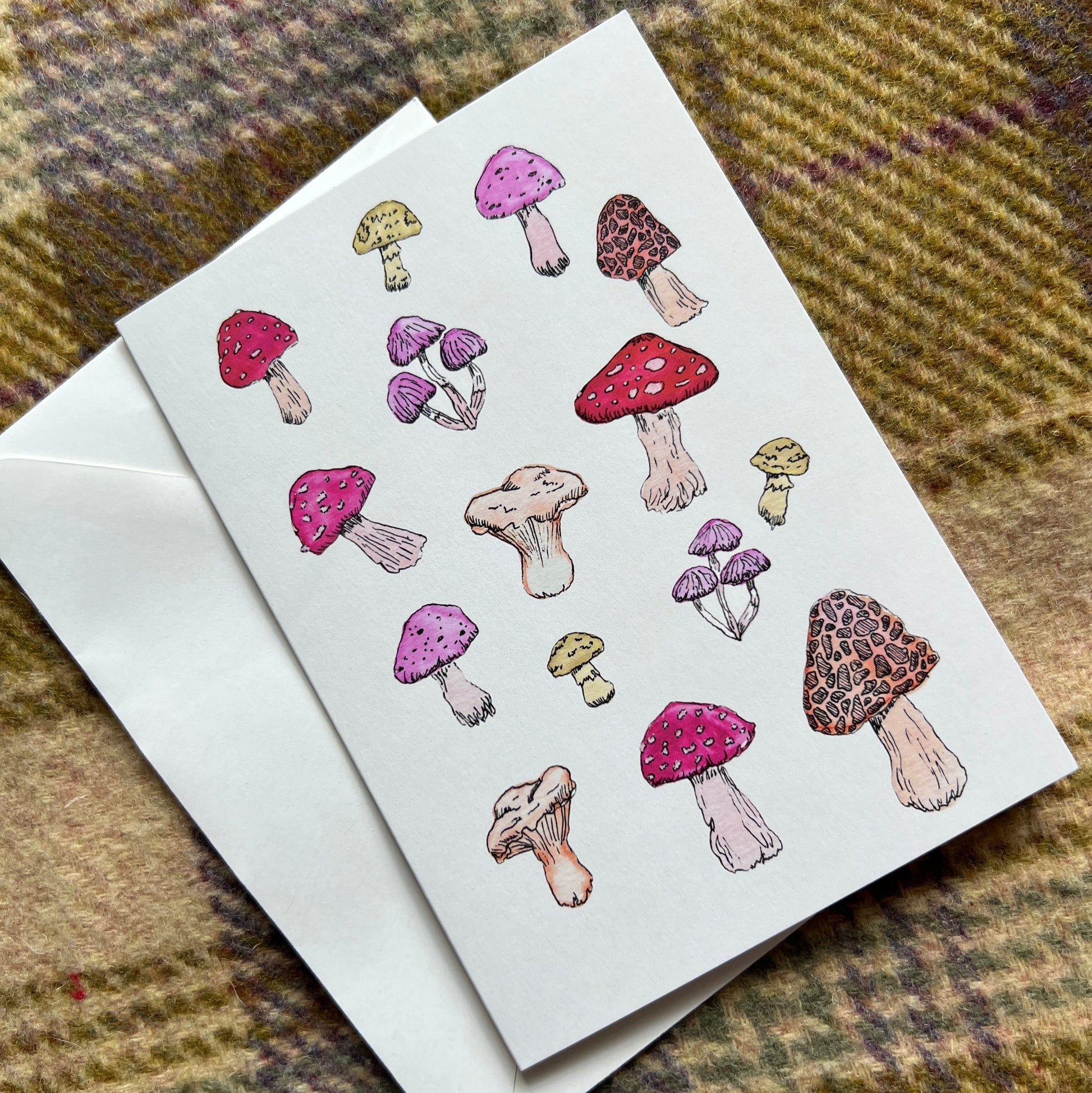 Card with colorful mushroom illustrations on a textured fabric background